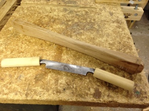 Shaving the crossmember with a draw knife reduces weight and gives the piece a pleasing shape.