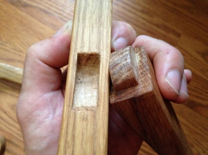The ends of the crossmember have a tenon, 1/2" wide by about 1-1/4" long, rounded to allow the bows to rock slightly as the string is tightened.